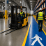 Busy industrial warehouse with forklifts